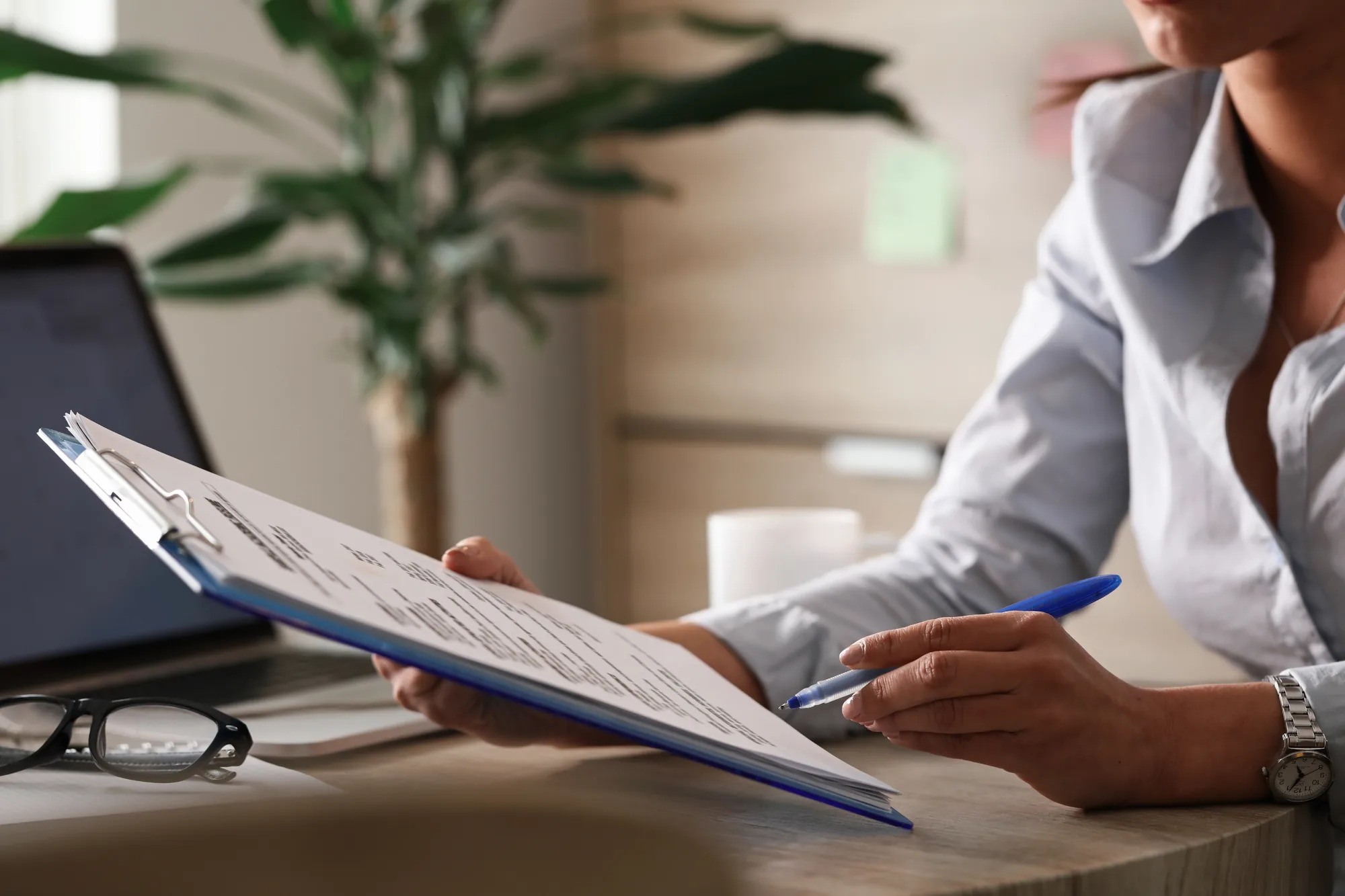 A person going through printed reports at a desk